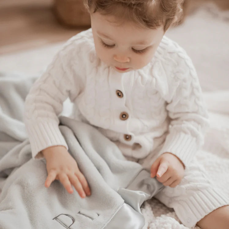 WHISPER WHITE HORSESHOE CABLE KNIT BABY JUMPSUIT